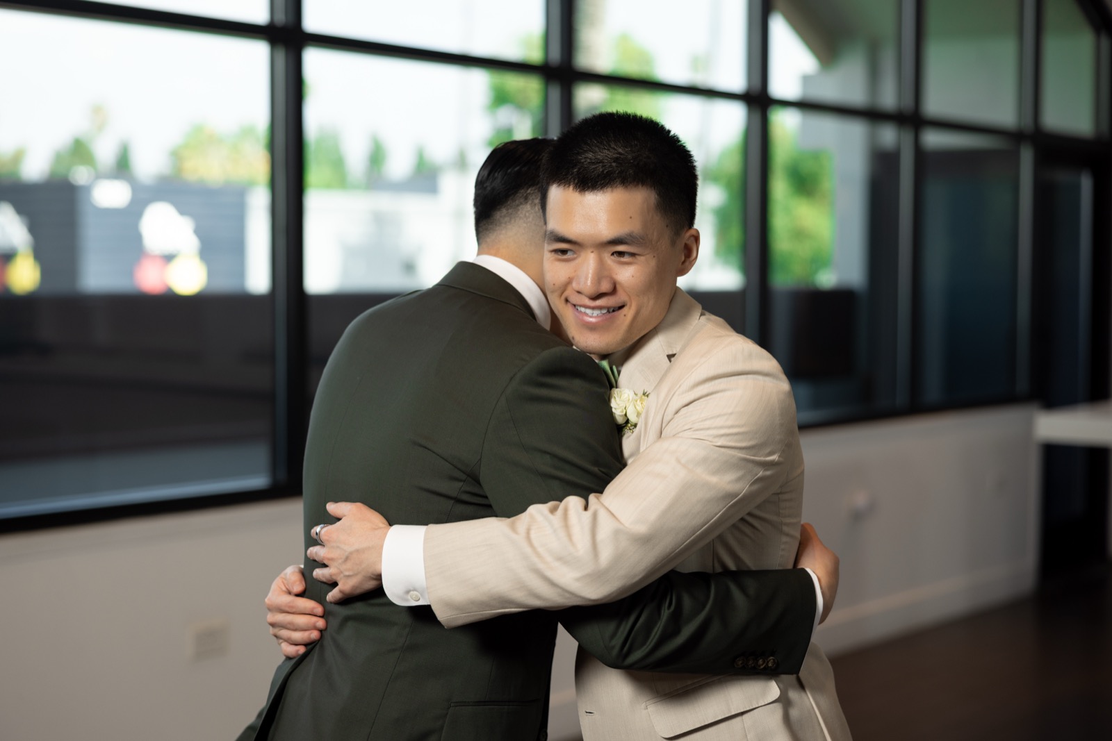 Kevin hugging his best man before the ceremony at The Colony House