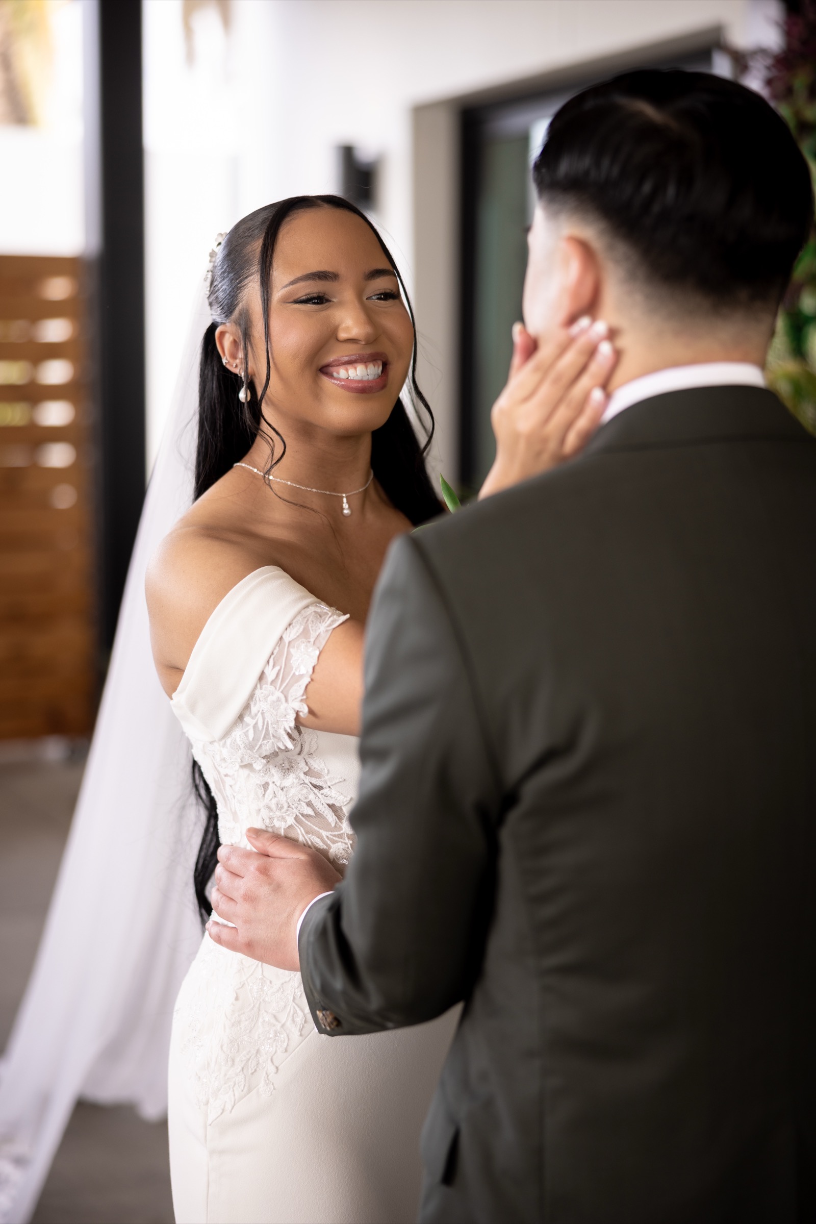 Rachel and her father standing together in front of the green wall at The Colony House