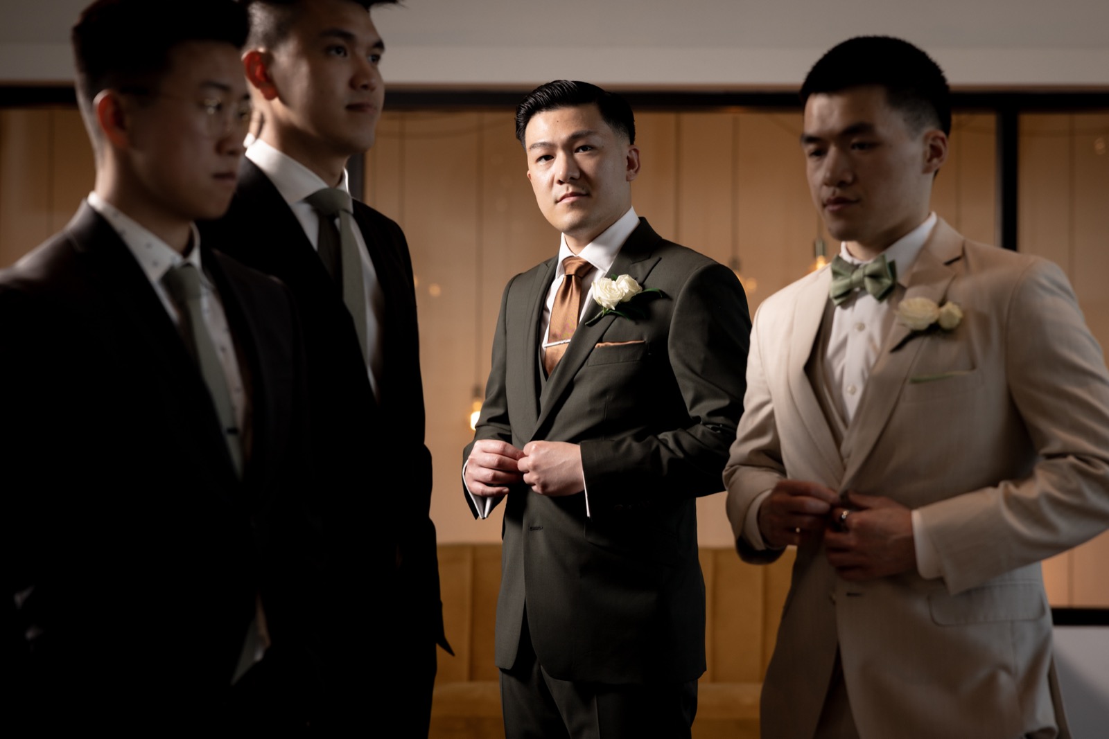 Rachel tapping Kevin's shoulder for their first look at The Colony House, living green wall backdrop