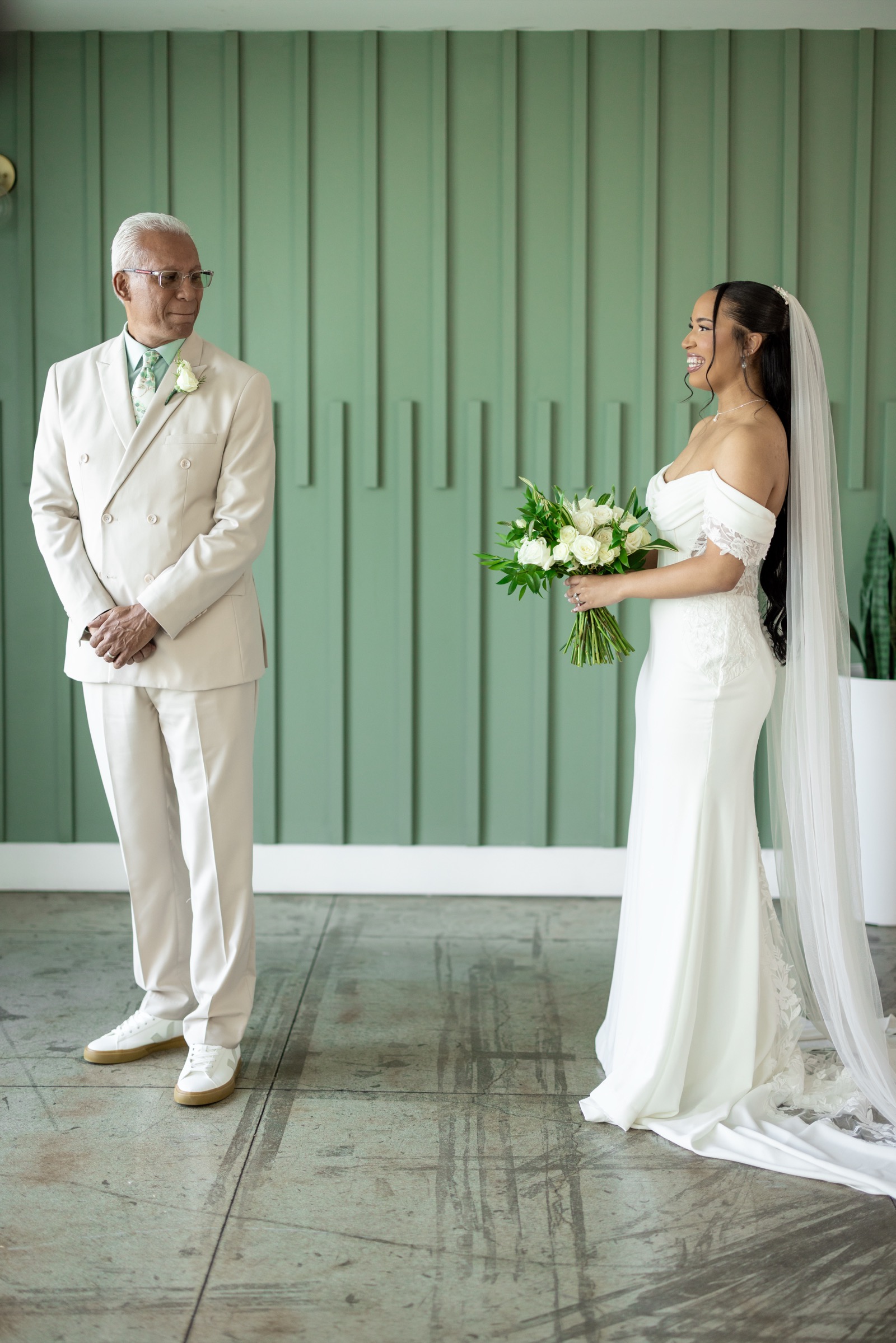 Rachel walking down the aisle with both parents at The Colony House wedding ceremony