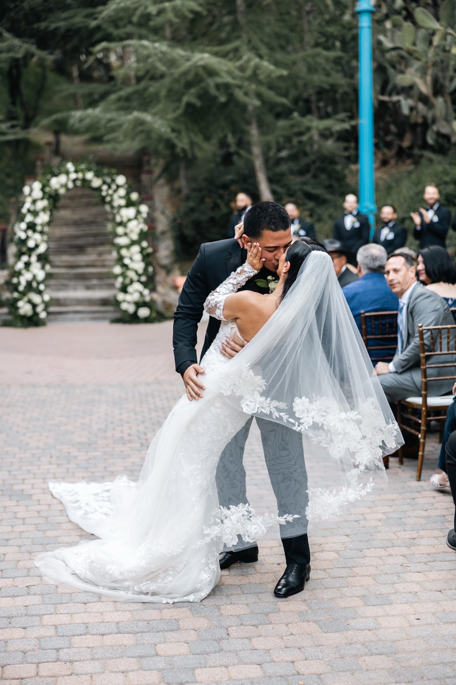Ceremony kiss dip with guests cheering at Rancho Las Lomas wedding
