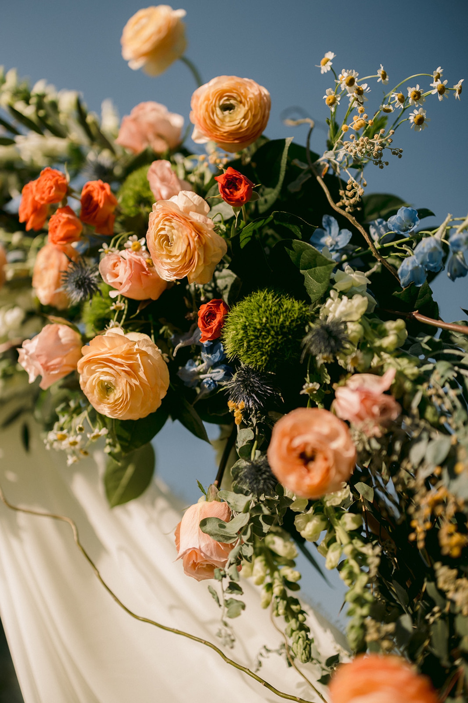 Close-up of ceremony flowers with ranunculus and roses