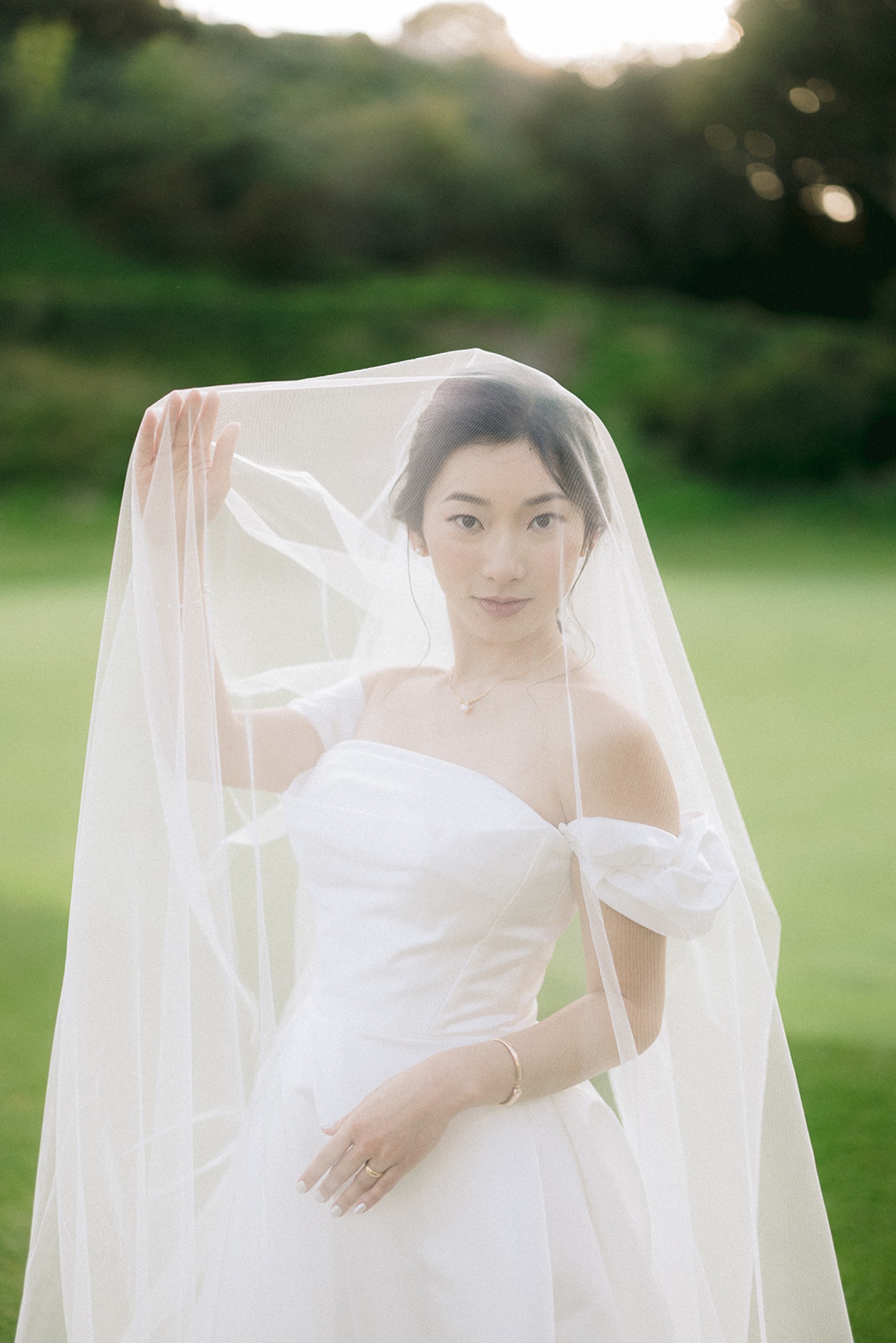 Bridal portrait with veil draped in golden light