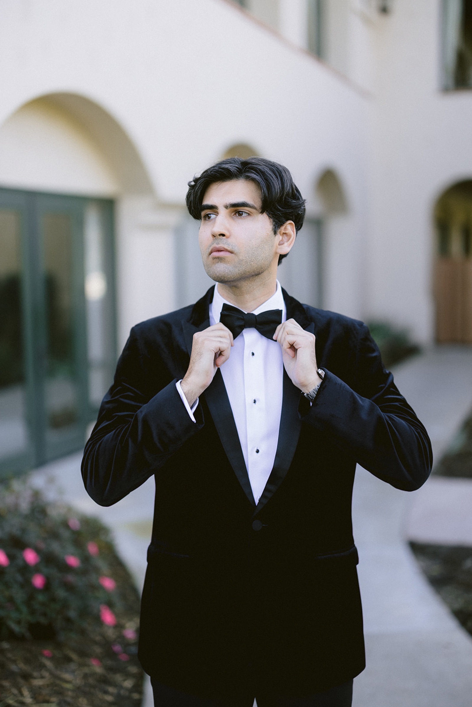 Shravan adjusting his bow tie before the first look