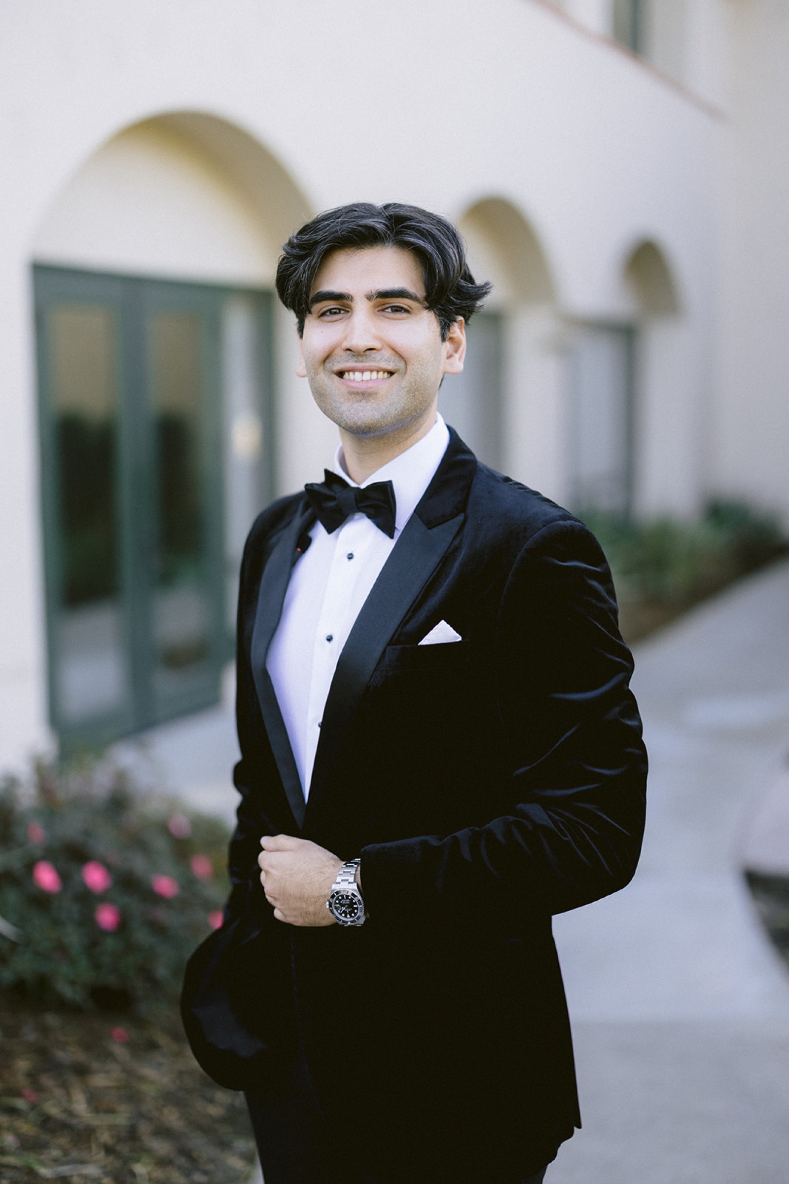 Groom smiling in velvet tuxedo at South Hills Country Club