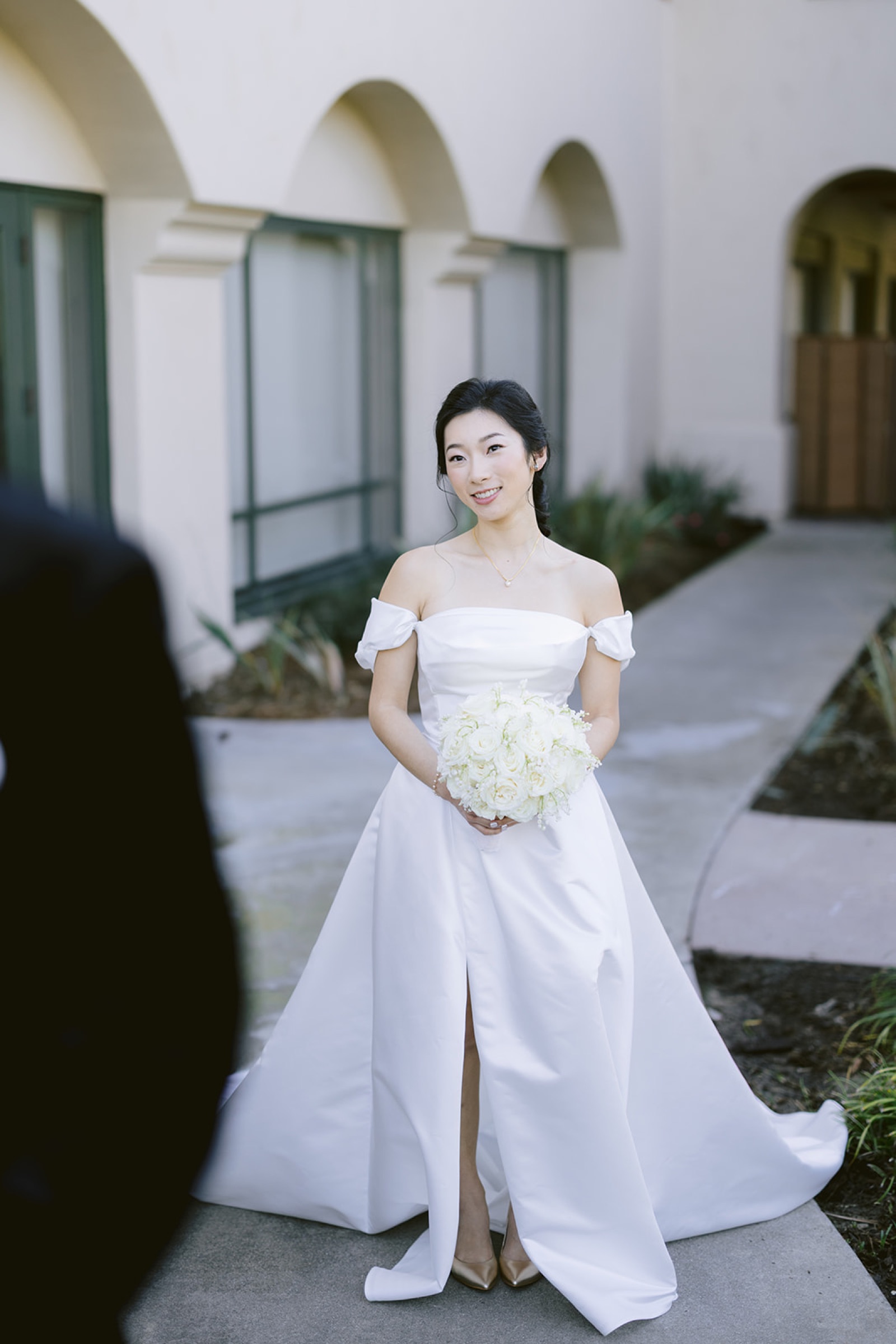 Kirsten in her wedding dress approaching Shravan for the first look