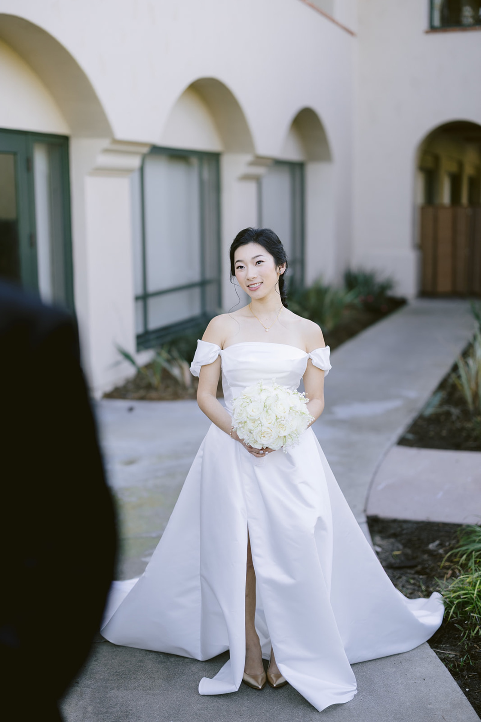 Bride walking toward groom during first look at South Hills
