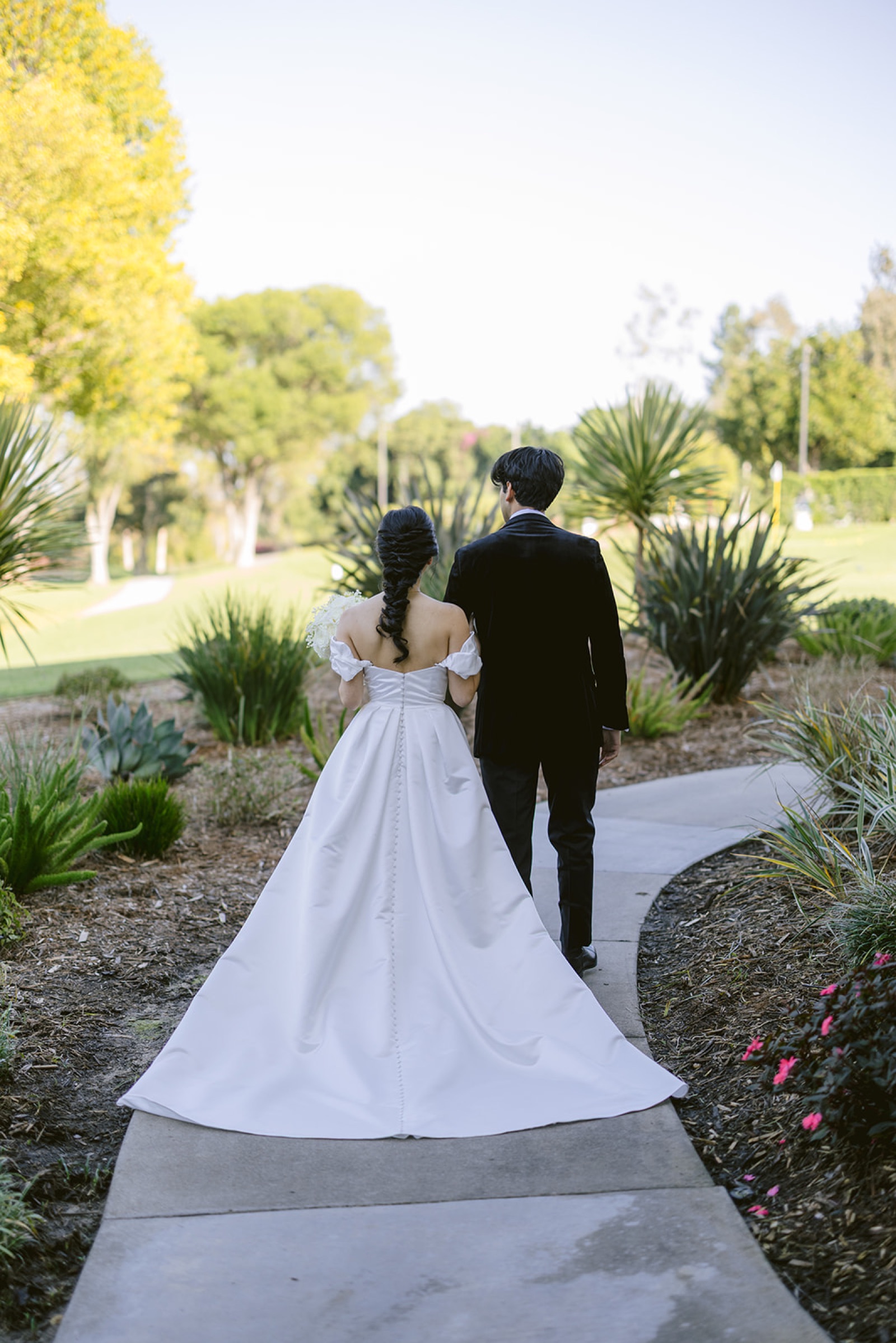 Couple walking through the gardens at South Hills Country Club