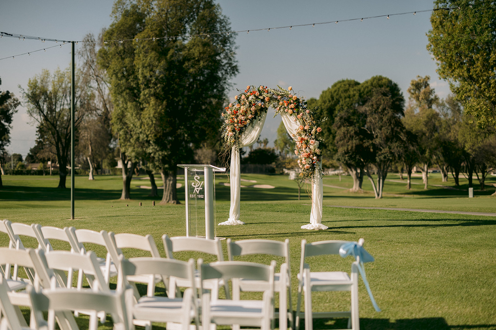 South Hills Country Club ceremony setup with floral arch on the golf course